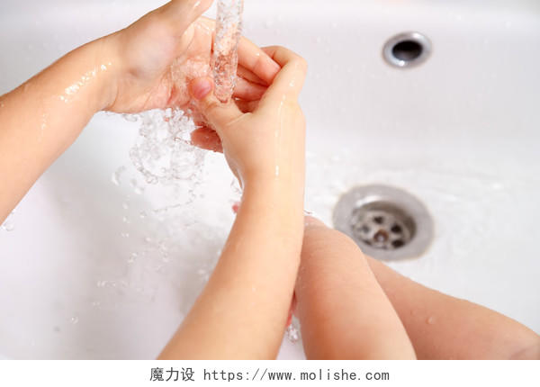 儿童在自来水下的白色水槽洗手